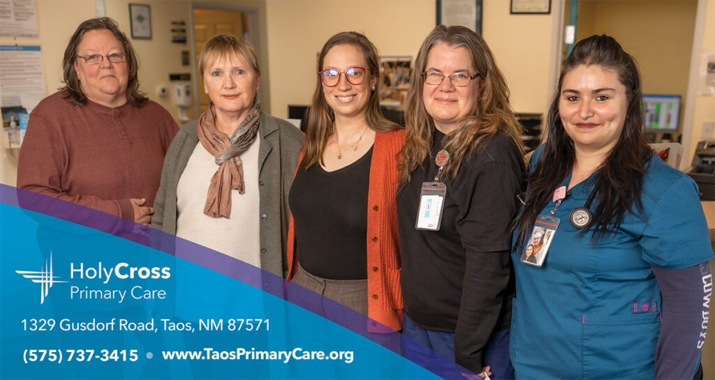 Five members of the primary care clinic team at Holy Cross standing in a row.