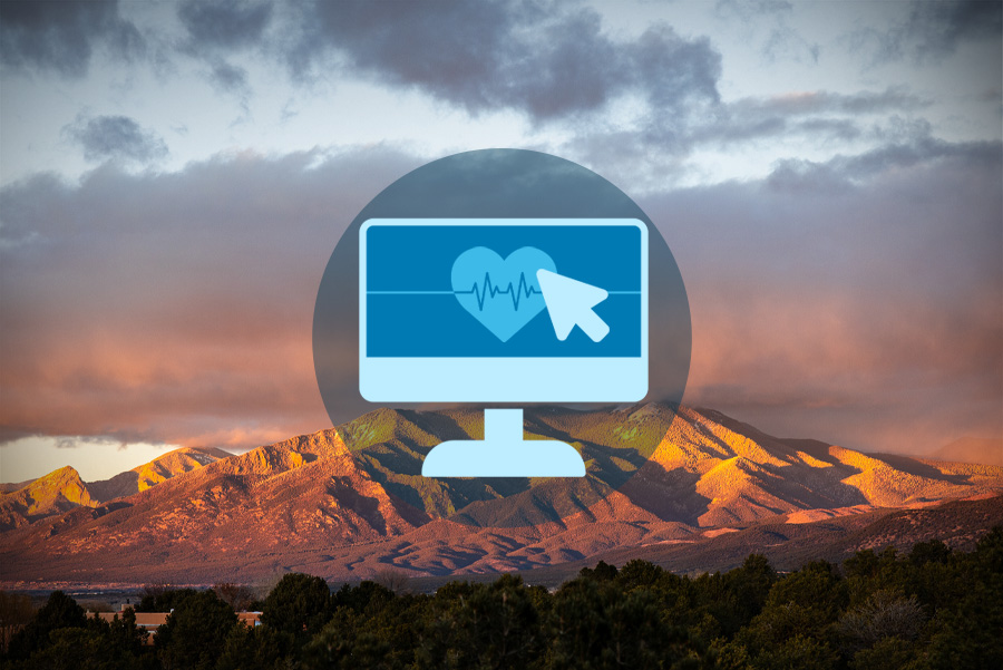 A computer screen with a heart monitor icon overlays a scenic mountain landscape, symbolizing health technology.